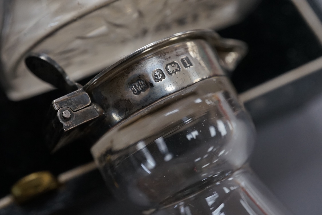 A cased pair of George V silver mounted glass whisky noggins, by S. Blanckensee & Sons, Birmingham, 1935, height 10.5cm, together with one other earlier whisky noggin, Hukin & Heath, Birmingham, 1908.